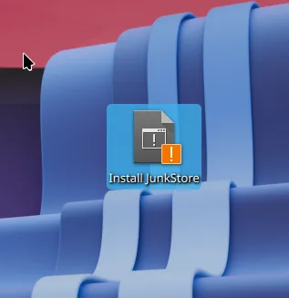 The Install JunkStore icon sitting on the Steam Deck desktop, with a small orange exclamation badge in the corner