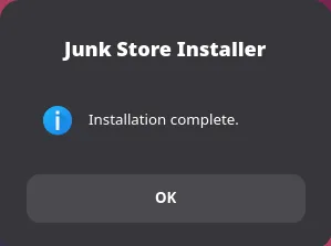 A small Junk Store Installer dialog with an information icon reading Installation complete, and an OK button